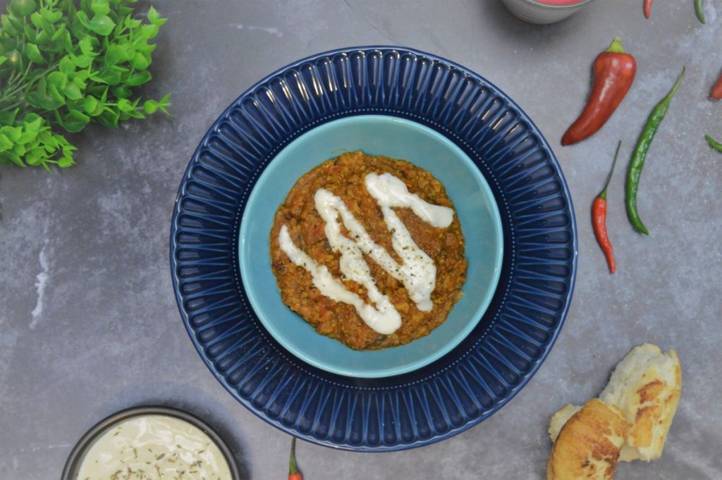bowl of vegan chilli with plain yogurt in a bowl, chilli's, bread and yogurt