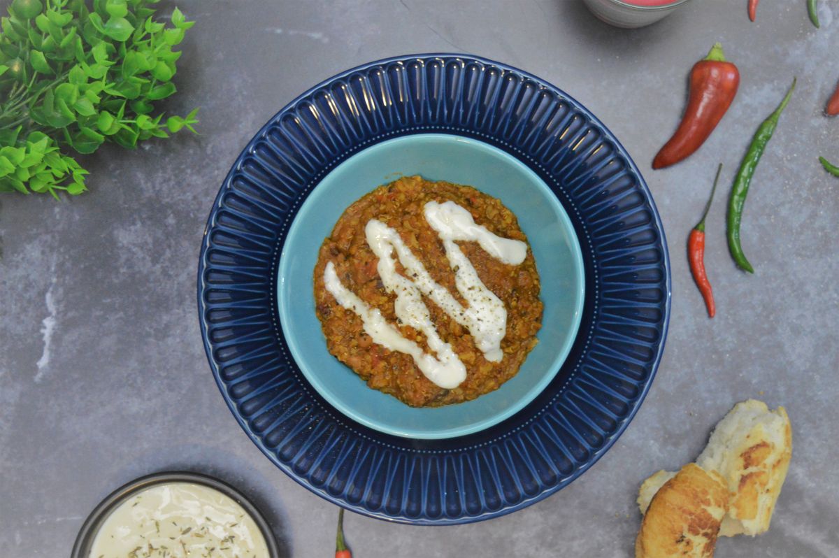 bowl of vegan chilli with plain yogurt in a bowl, chilli's, bread and yogurt