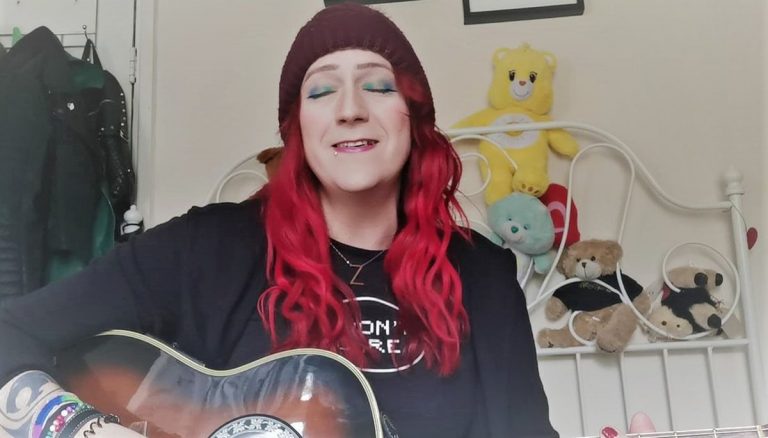 transwoman playing guitar